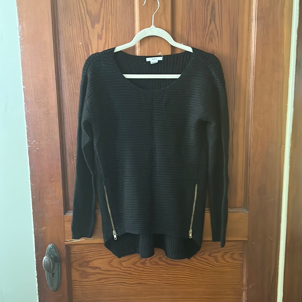 Black knit sweater with gold zippers on the side